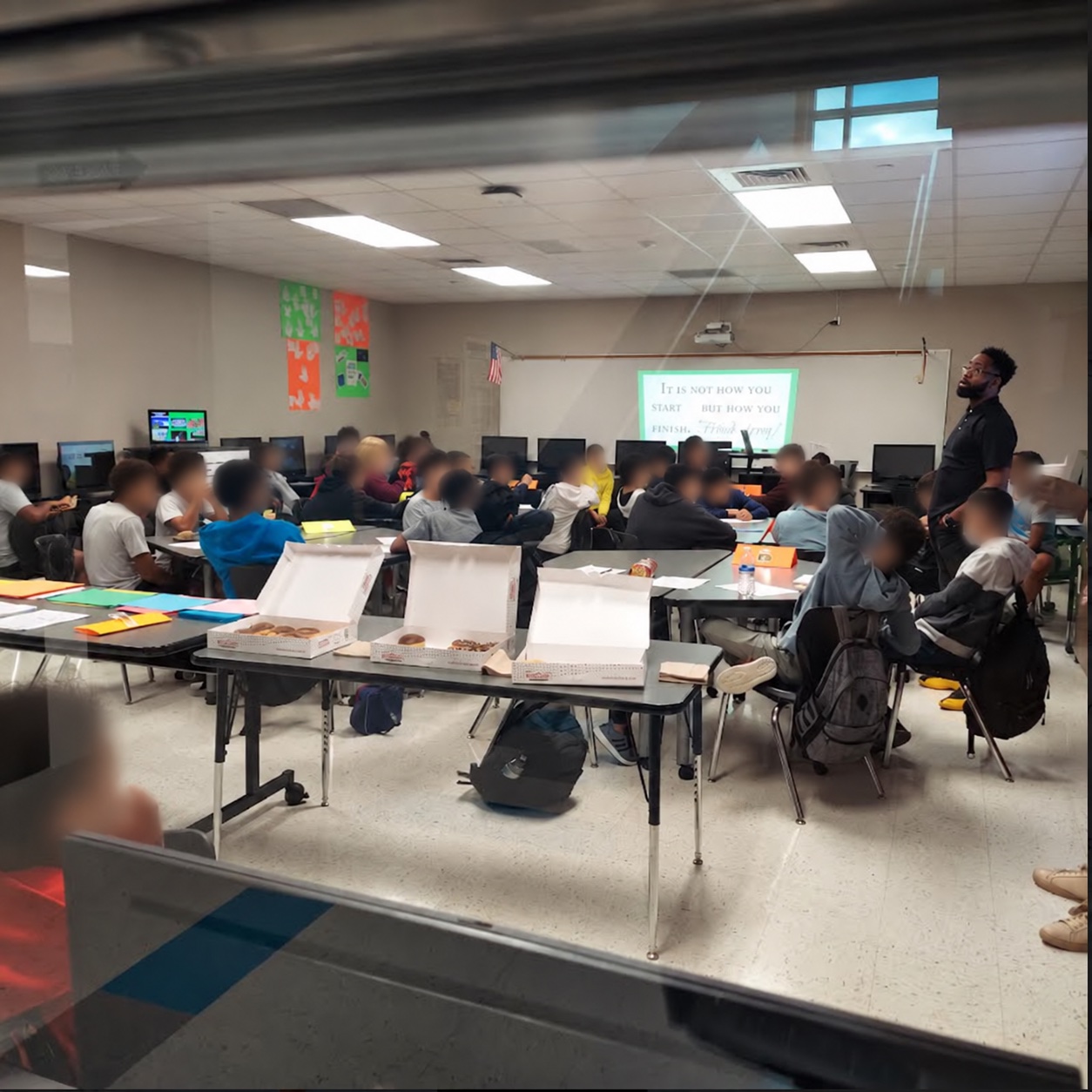 Coach working with a room of middle school students during a session
